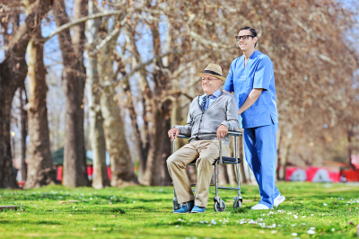 caregiver assisting senior man in wheelchair